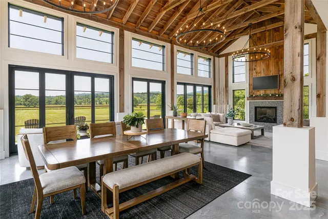 a living room with furniture a fireplace and a table