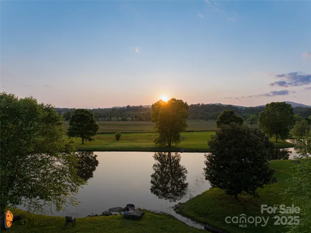 an aerial view of lake and residential houses with outdoor space