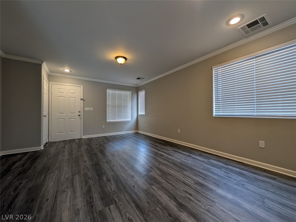 10308 Faustine Avenue Las Vegas, NV 89129 - Photo 4 of 28 Rich wood flooring grounds this naturally illuminated living space, complete with classic crown molding.