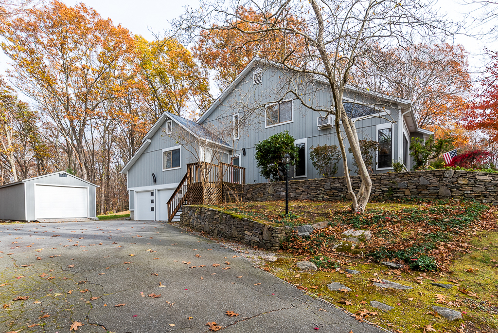 a front view of a house with a tree