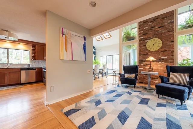 a kitchen with stainless steel appliances granite countertop a sink refrigerator and cabinets
