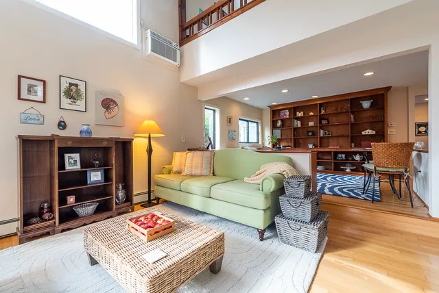 a living room with furniture a fireplace and a large window