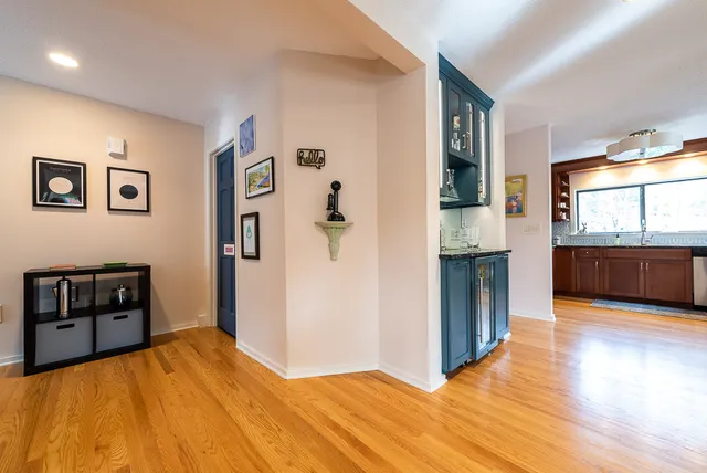 a living room with furniture a large window and wooden floor