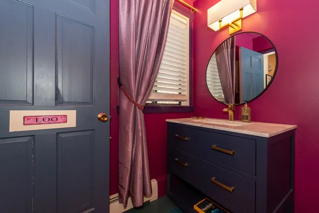 a view of a bedroom with wooden floor and windows