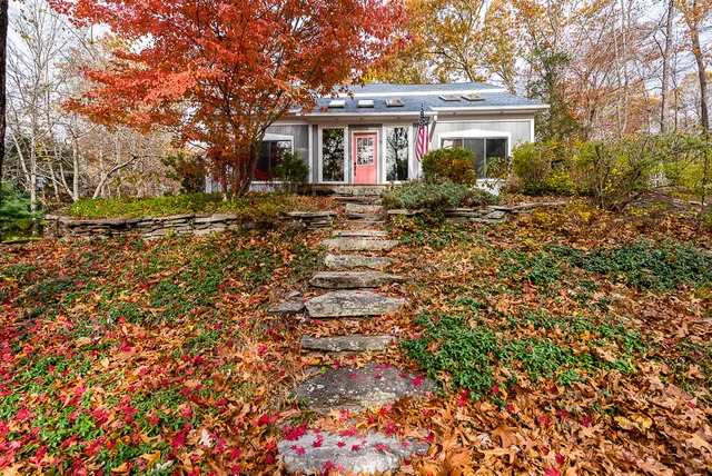 a backyard of a house with large trees
