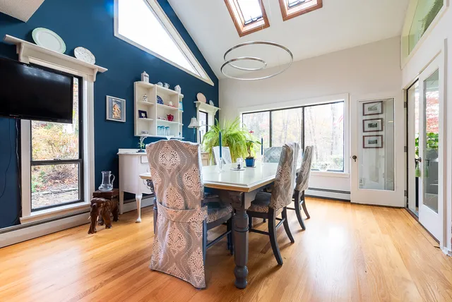 a view of a dining room with furniture and wooden floor