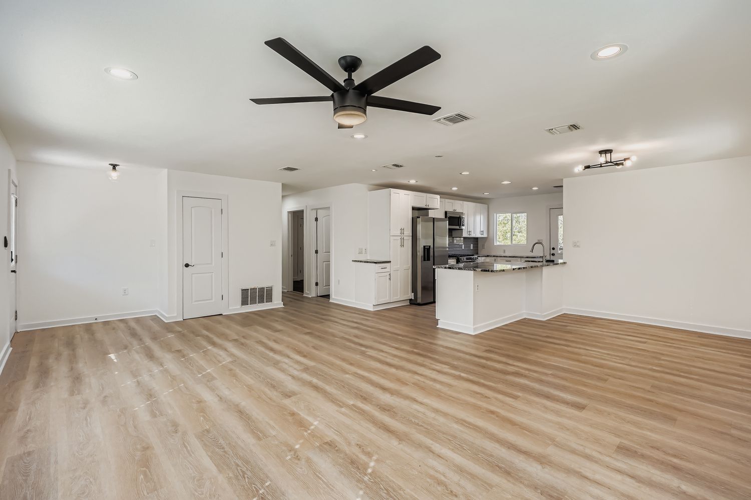 112 Tenorio Street Kyle, TX 78640 - Photo 2 of 11 a view of kitchen with stainless steel appliances refrigerator stove microwave and cabinets