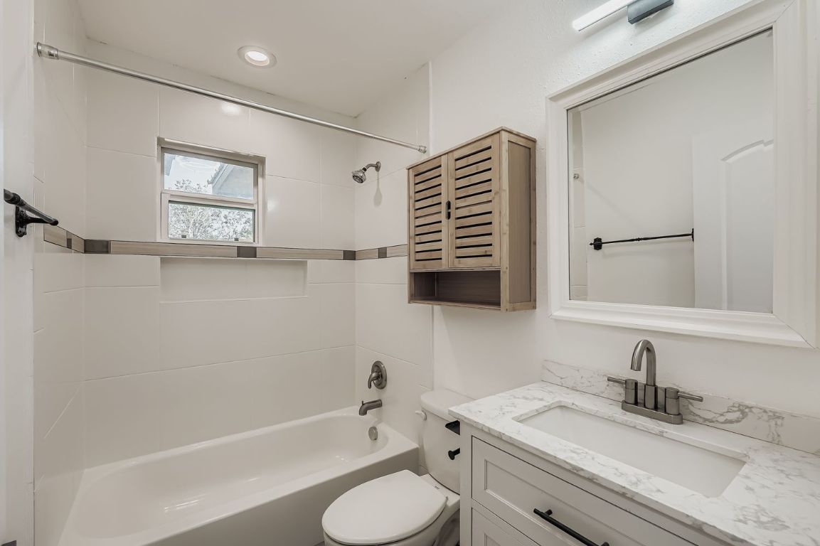 112 Tenorio Street Kyle, TX 78640 - Photo 8 of 11 a bathroom with a granite countertop sink toilet and shower