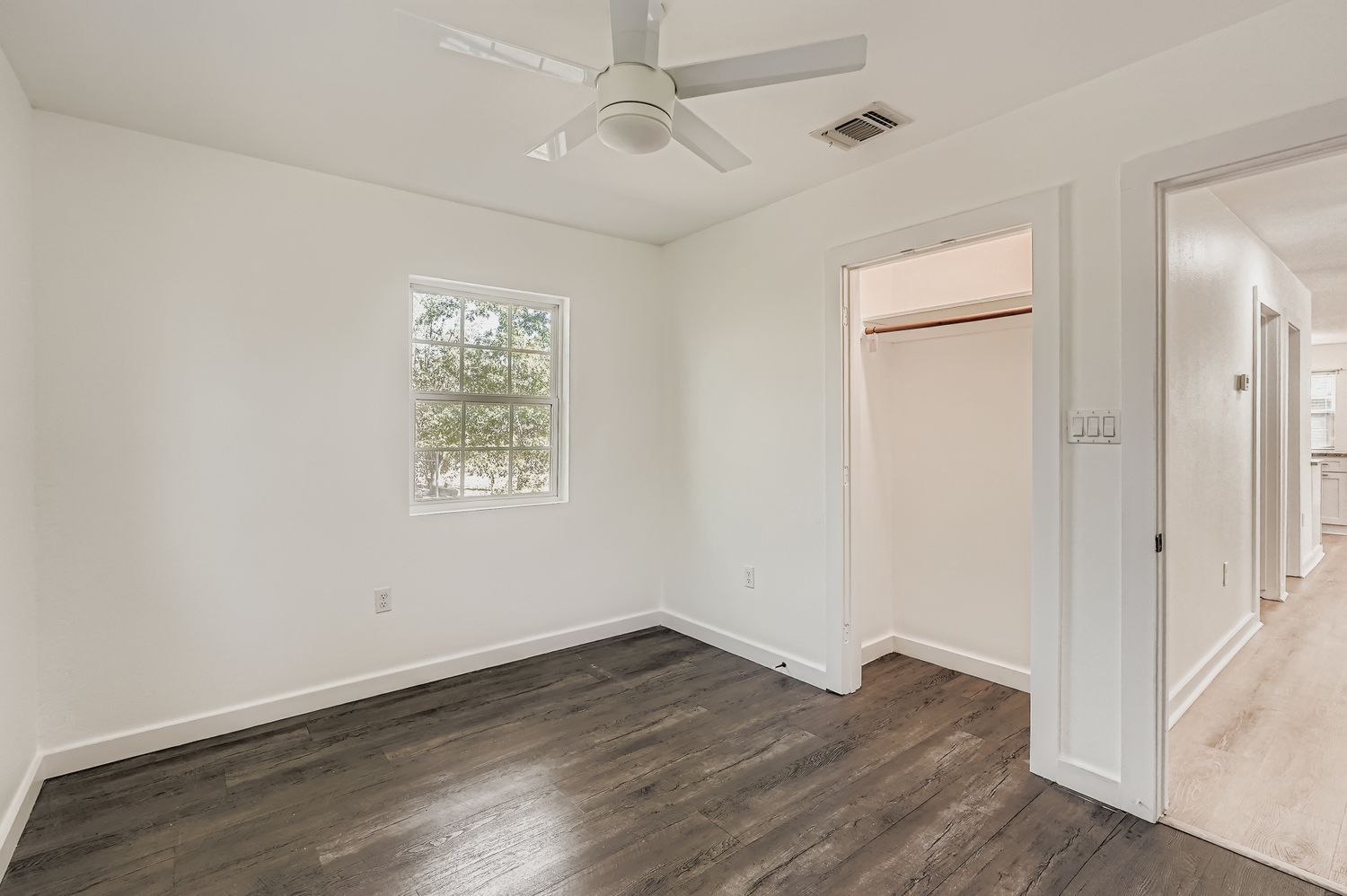 112 Tenorio Street Kyle, TX 78640 - Photo 9 of 11 wooden floor in an empty room with a window