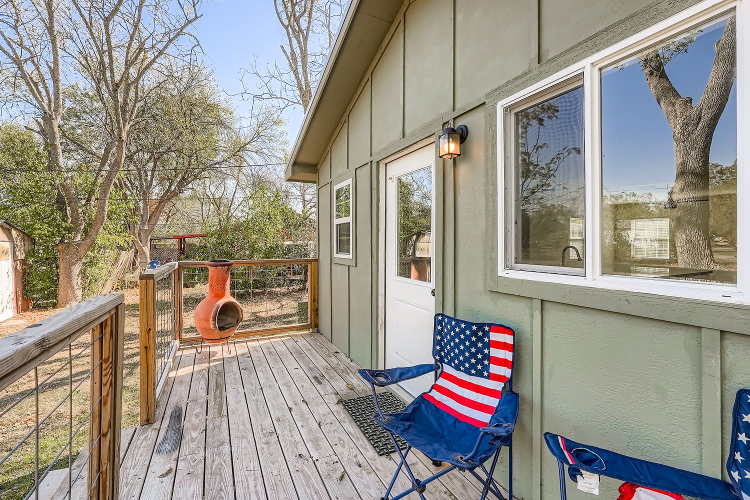 112 Tenorio Street Kyle, TX 78640 - Photo 10 of 11 a balcony with chairs and wooden floor