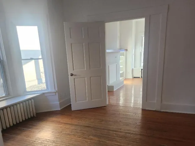 a kitchen with stainless steel appliances granite countertop white cabinets and a stove top oven