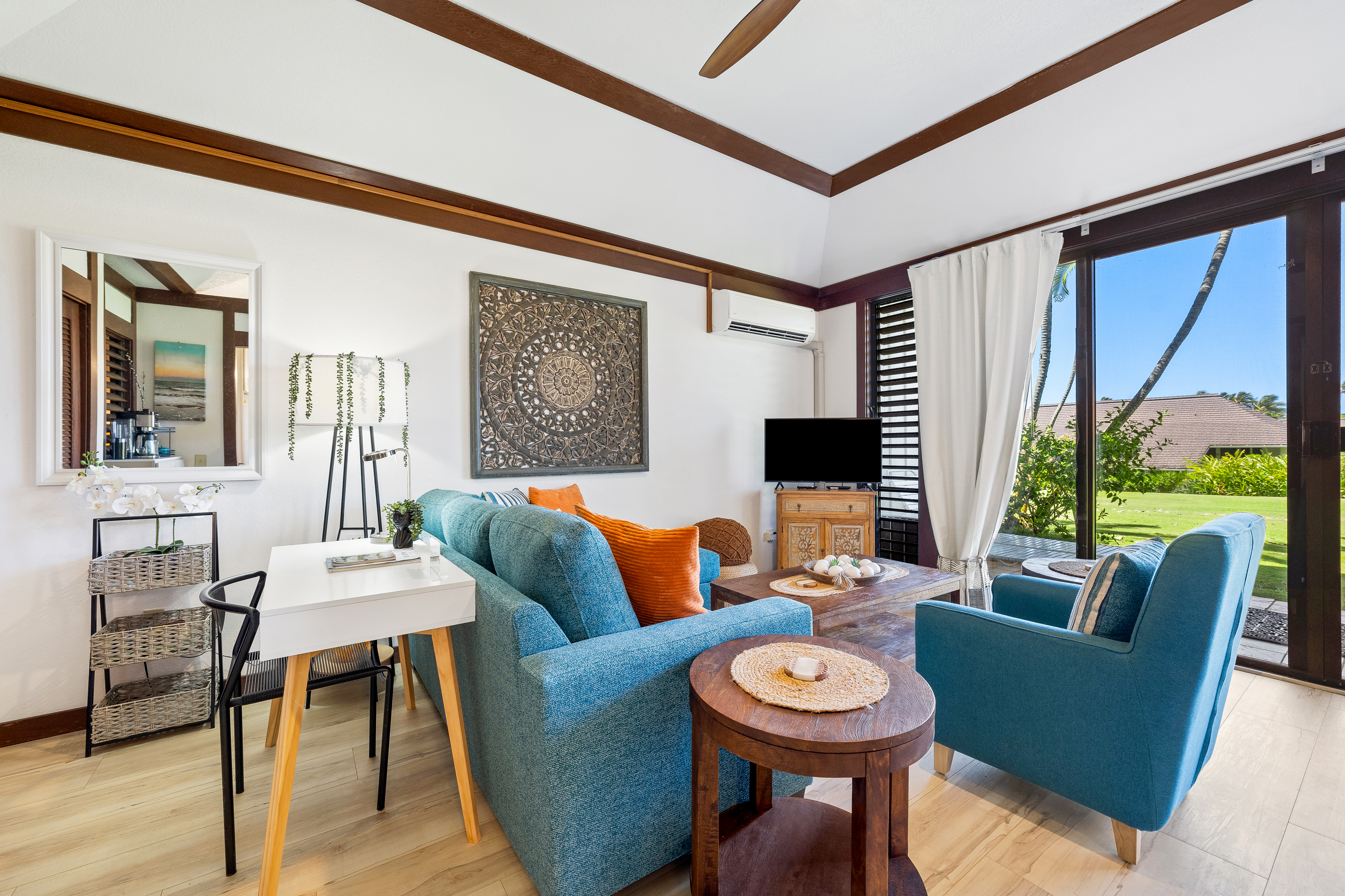 2253 Poipu Road, Unit 85 Koloa, HI 96756 - Photo 3 of 14 a living room with furniture a flat screen tv and a large window
