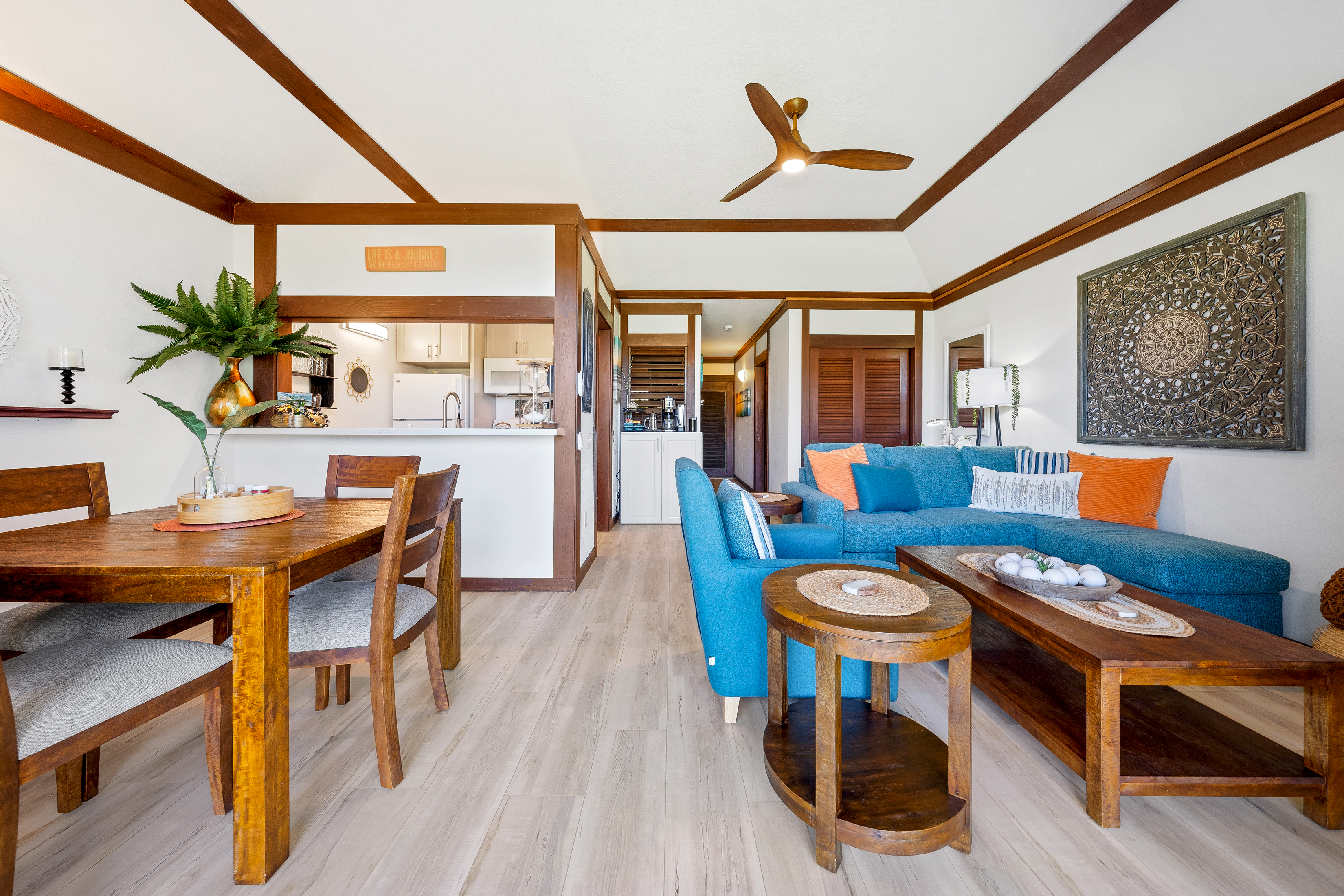 2253 Poipu Road, Unit 85 Koloa, HI 96756 - Photo 5 of 14 a living room with furniture a wooden floor and a window