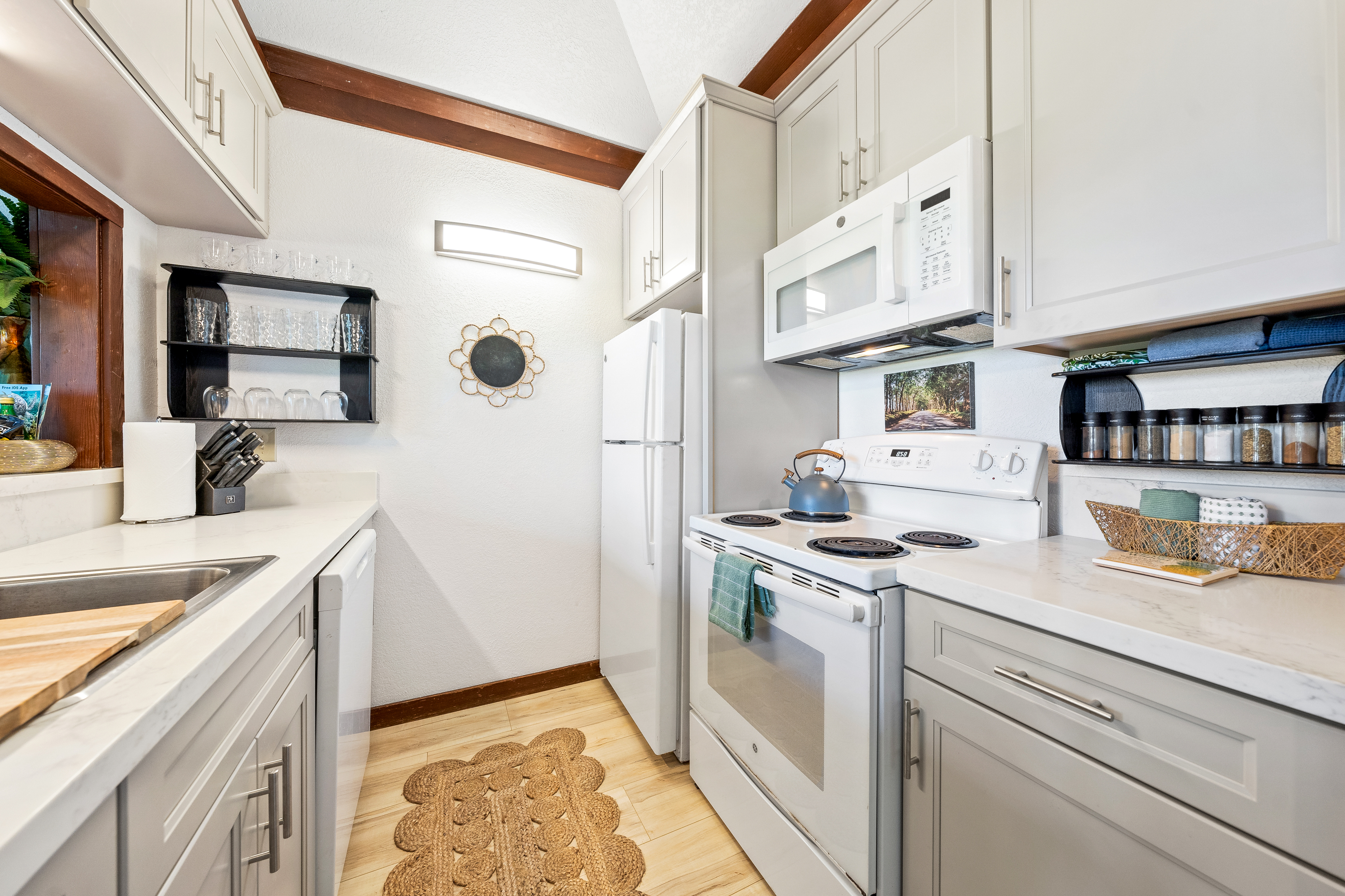 2253 Poipu Road, Unit 85 Koloa, HI 96756 - Photo 7 of 14 a kitchen with stainless steel appliances granite countertop a sink and a stove