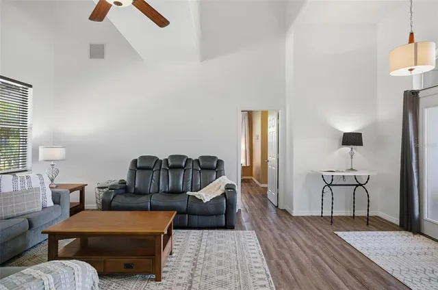 a kitchen with granite countertop cabinets stainless steel appliances and wooden floor