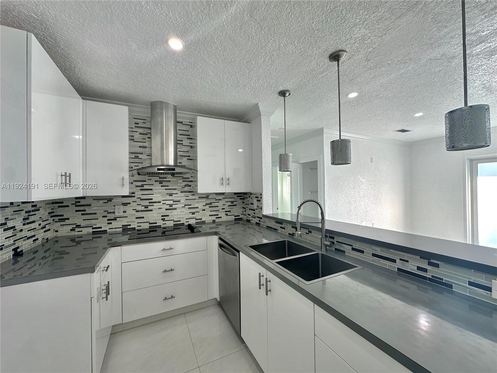 1211 West 34th Street, Unit FRONT Hialeah, FL 33012 - Photo 14 of 15 a kitchen with a sink stove and cabinets