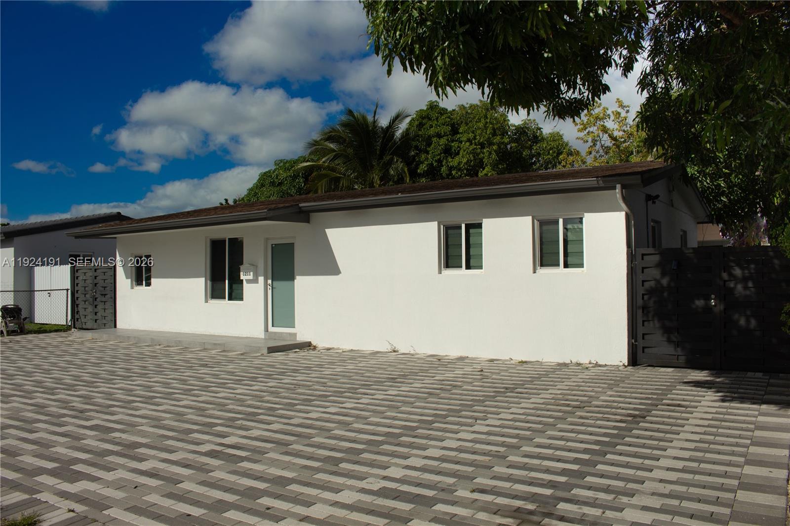 1211 West 34th Street, Unit FRONT Hialeah, FL 33012 - Photo 15 of 15 a house with trees in the background