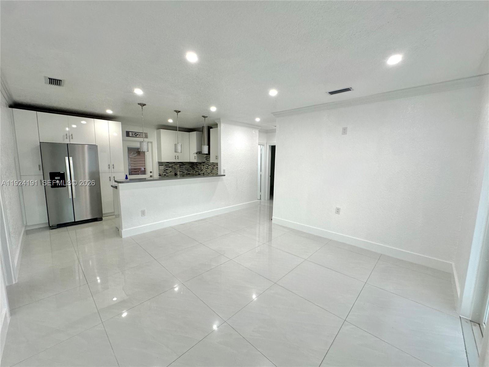 1211 West 34th Street, Unit FRONT Hialeah, FL 33012 - Photo 2 of 15 a view of a kitchen with a refrigerator and a sink