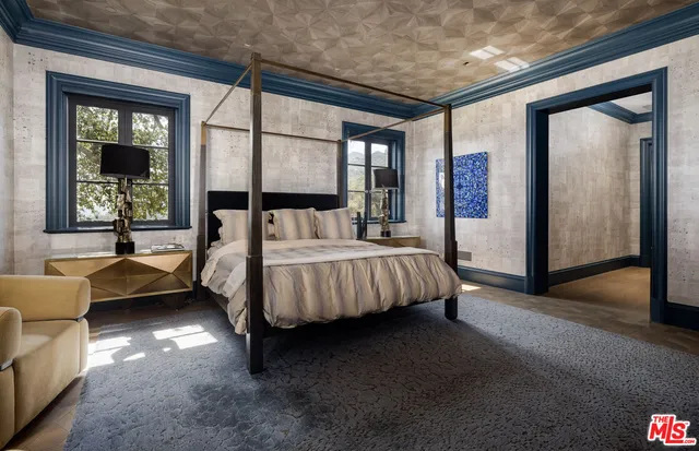 a bedroom with a bed and a couch next to a window