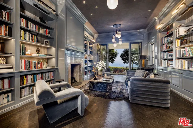 a living room with furniture and a book shelf