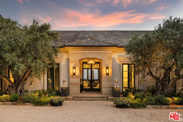 front view of a brick house with a small yard