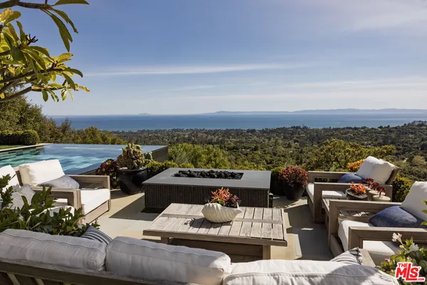 a view of a terrace with couches and lounge chairs