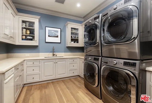 a utility room with sink dryer and washer