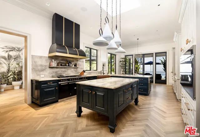 a kitchen with stainless steel appliances granite countertop a stove and a sink
