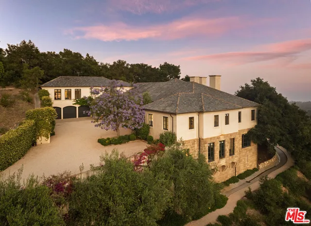aerial view of a house with a yard and balcony
