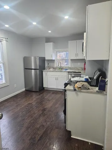 a kitchen with a sink a stove a refrigerator and cabinets