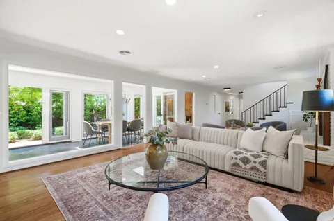 a living room with furniture and a rug