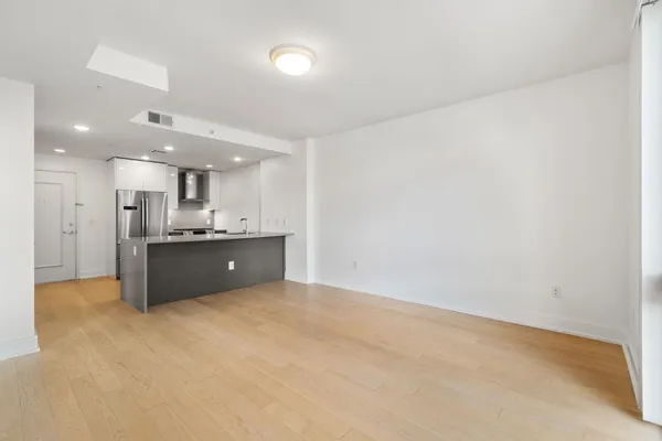 a large white kitchen with a sink and cabinets