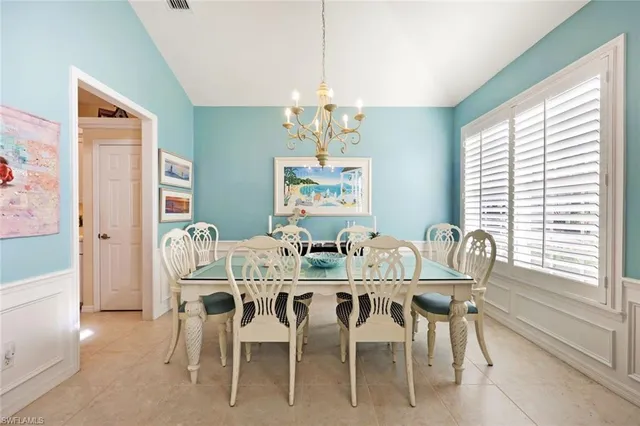 a dining room with furniture a rug and a chandelier