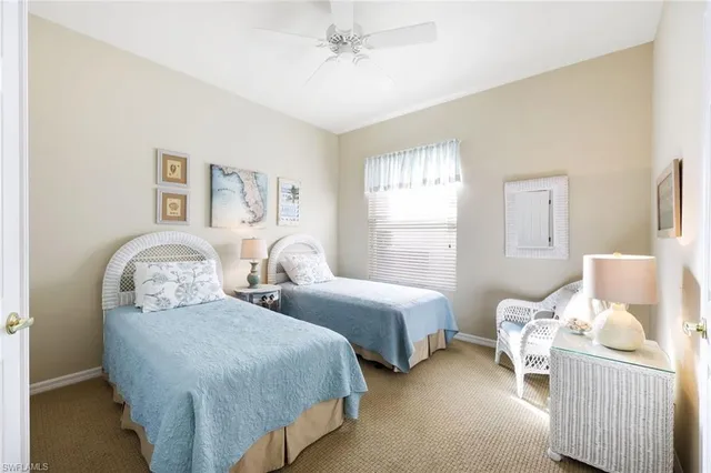 a bedroom with two beds and a window