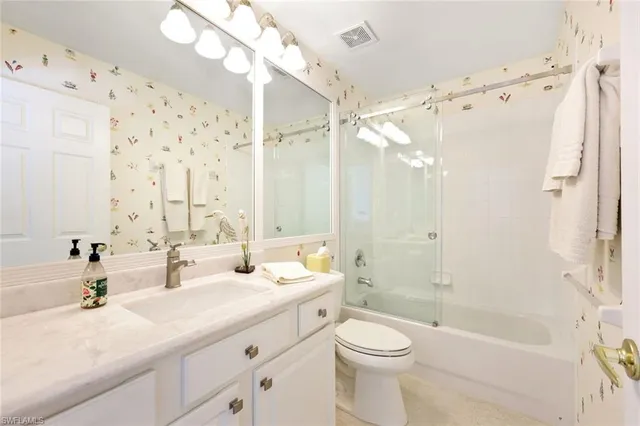 a bathroom with a double vanity sink mirror double and shower
