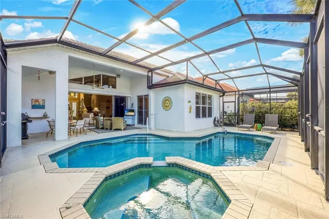 a view of a swimming pool with outdoor seating