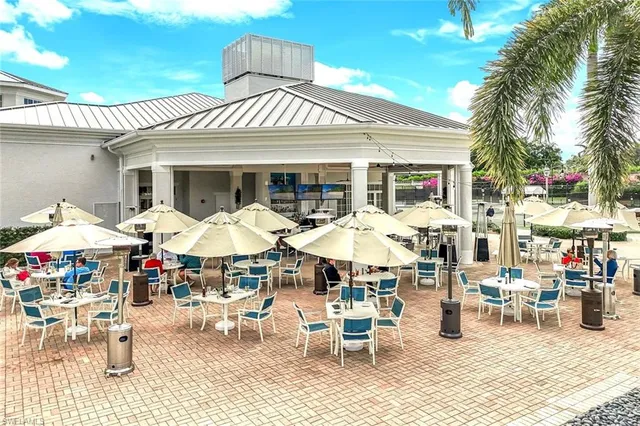 a group of people sitting outside of a restaurant