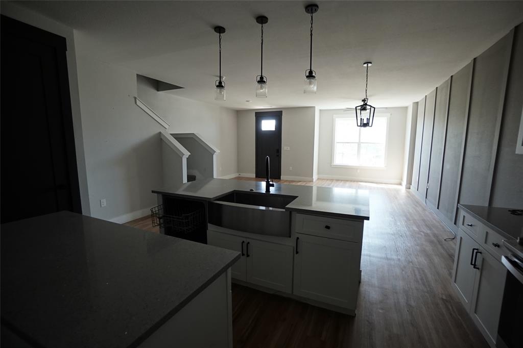1764 Palladio Loop Princeton, TX 75407 - Photo 8 of 40 Kitchen island featuring a stainless steel farmhouse sink and dark countertops