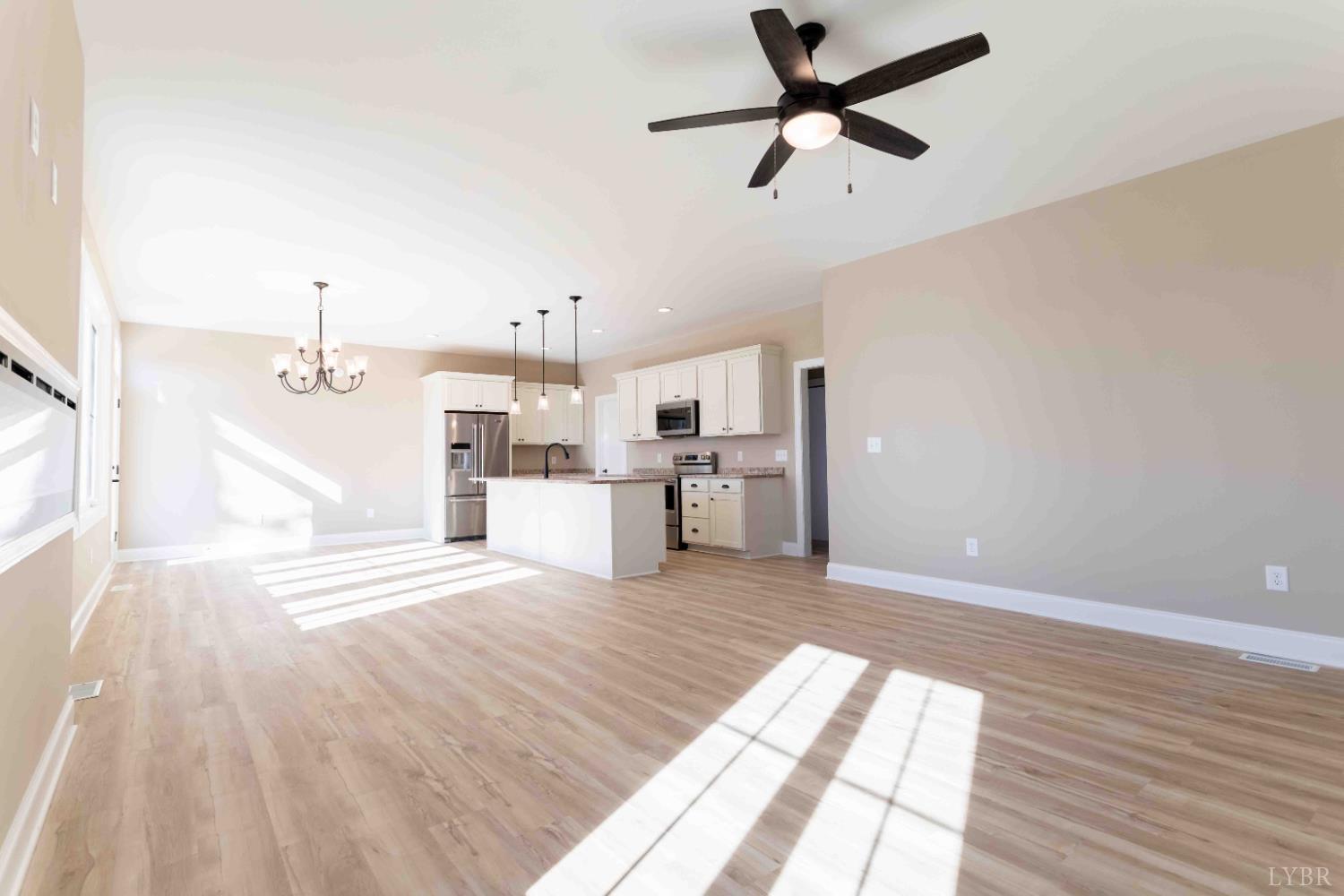 1115 Thornblade Way Blue Ridge, VA 24064 - Photo 11 of 44 a view of a kitchen with wooden floor and a ceiling fan