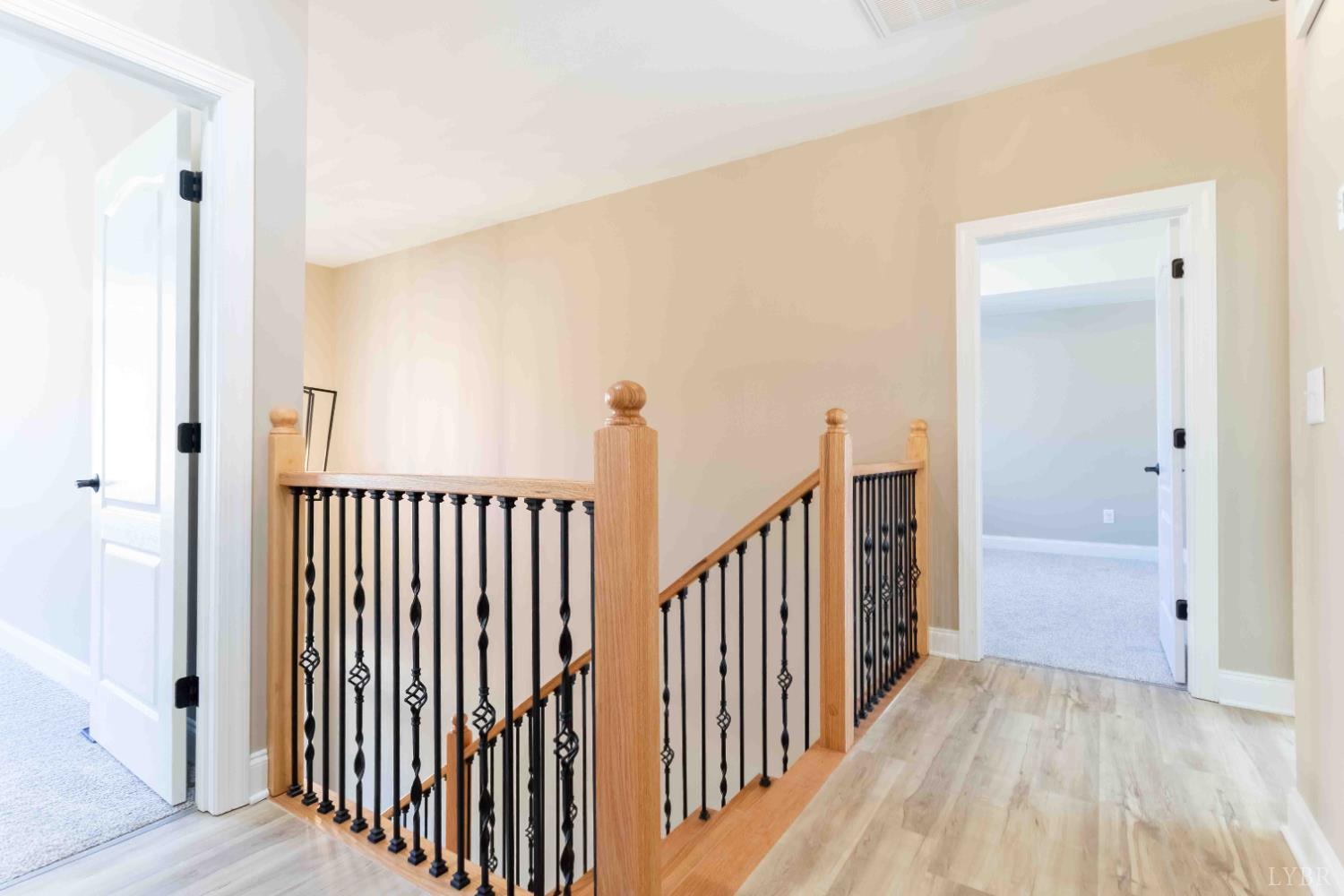 1115 Thornblade Way Blue Ridge, VA 24064 - Photo 19 of 44 a view of a hallway with wooden floor and stairs