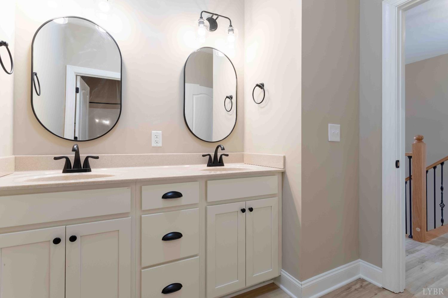 1115 Thornblade Way Blue Ridge, VA 24064 - Photo 20 of 44 a bathroom with a double vanity sink and a mirror