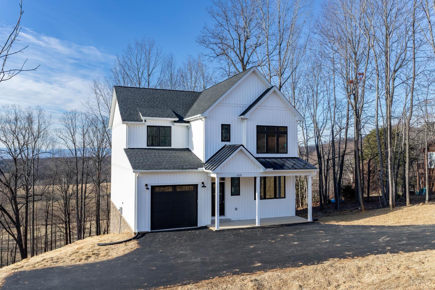 1115 Thornblade Way Blue Ridge, VA 24064 - Photo 2 of 44 a front view of a house with a garden