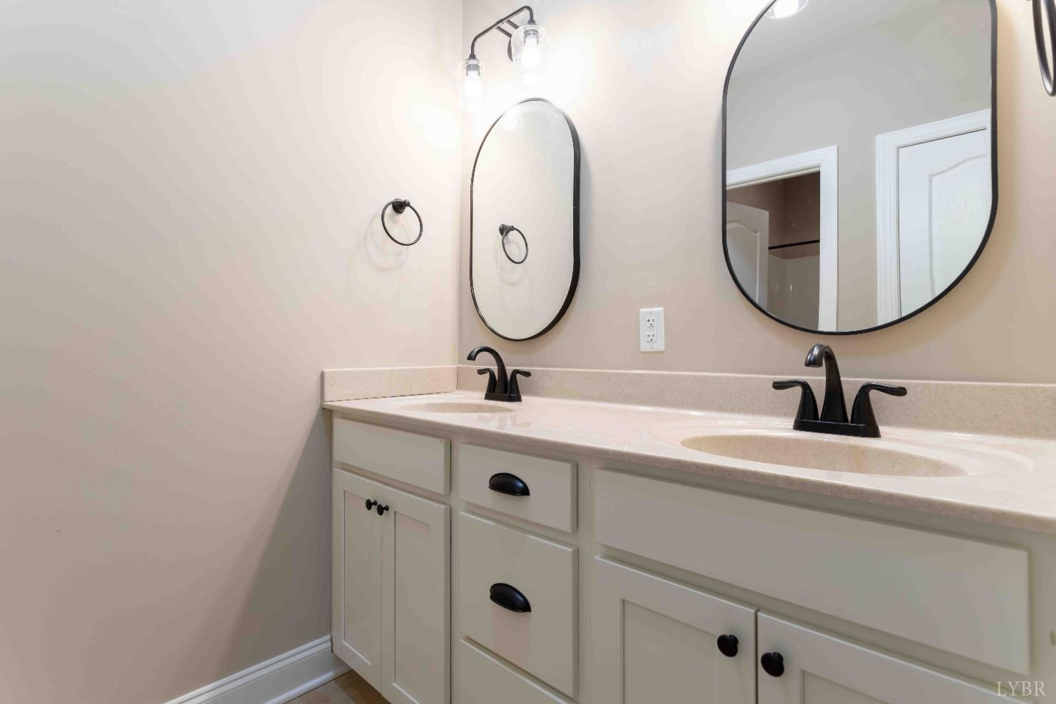 1115 Thornblade Way Blue Ridge, VA 24064 - Photo 21 of 44 a bathroom with a double vanity sink and mirror
