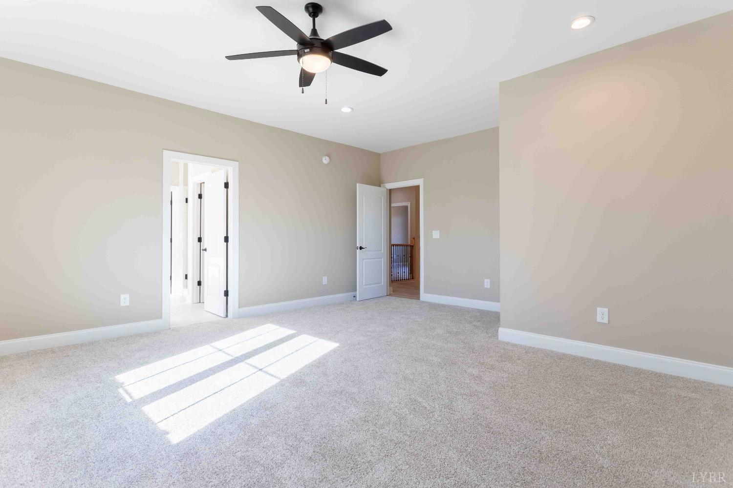 1115 Thornblade Way Blue Ridge, VA 24064 - Photo 29 of 44 a view of a big room with a ceiling fan and windows