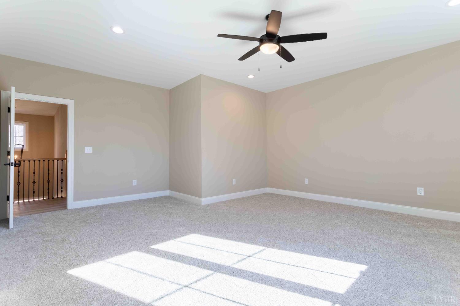 1115 Thornblade Way Blue Ridge, VA 24064 - Photo 30 of 44 an empty room with a ceiling fan and window