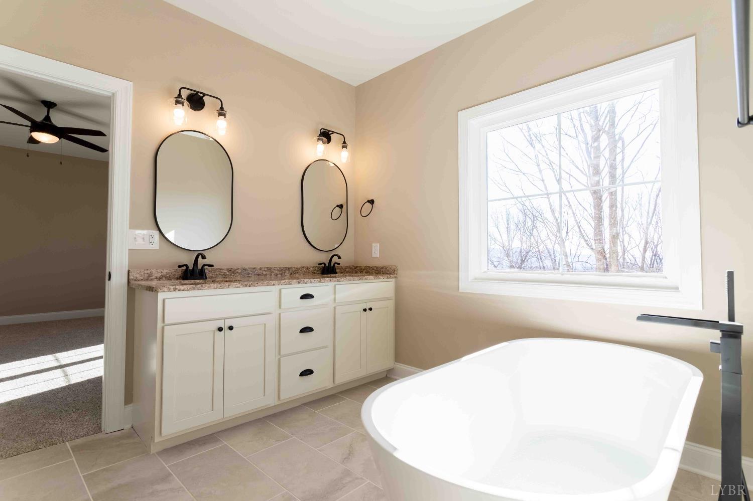 1115 Thornblade Way Blue Ridge, VA 24064 - Photo 33 of 44 a bathroom with a granite countertop sink and a mirror