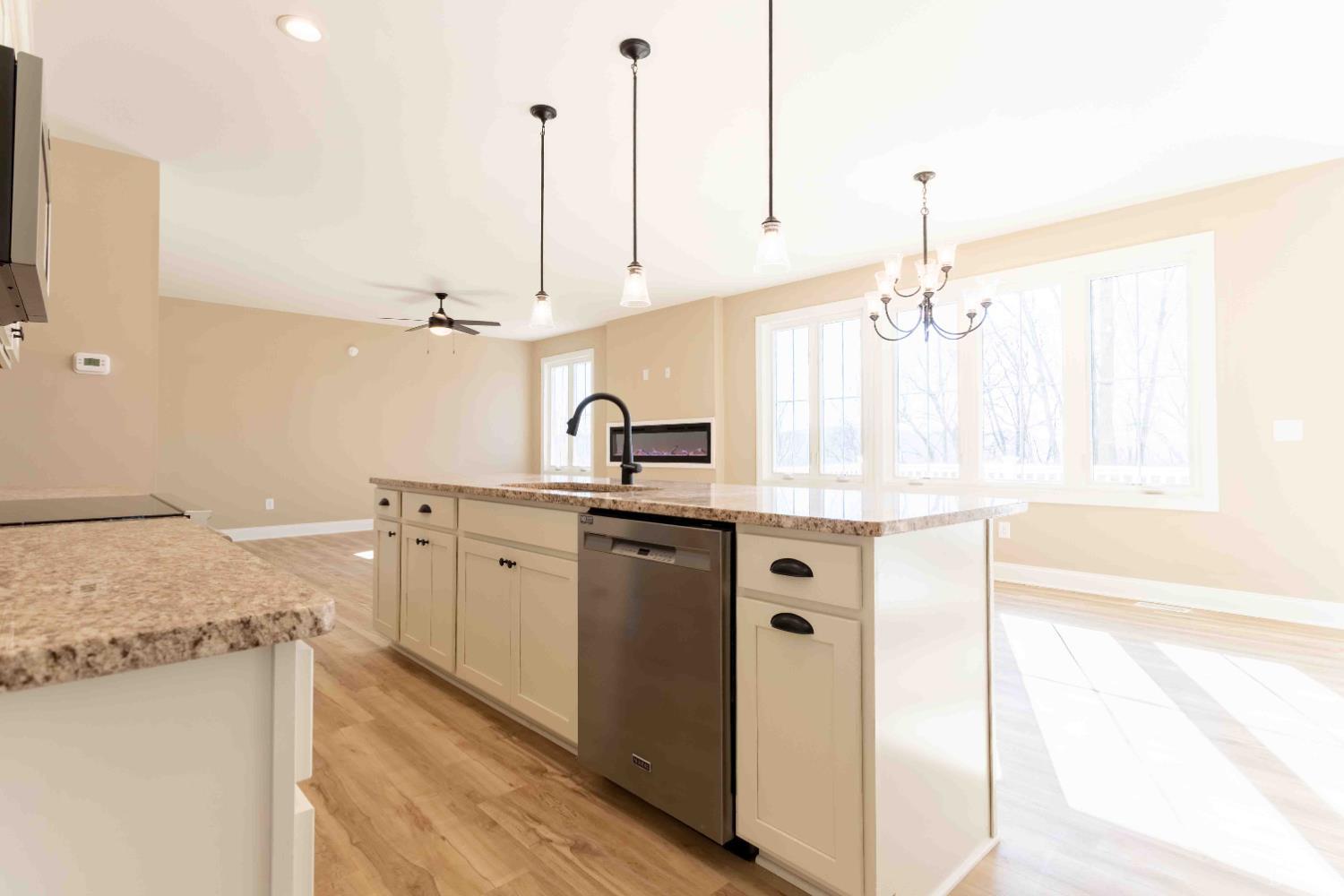 1115 Thornblade Way Blue Ridge, VA 24064 - Photo 7 of 44 a kitchen with stainless steel appliances granite countertop a sink a stove and a wooden floor