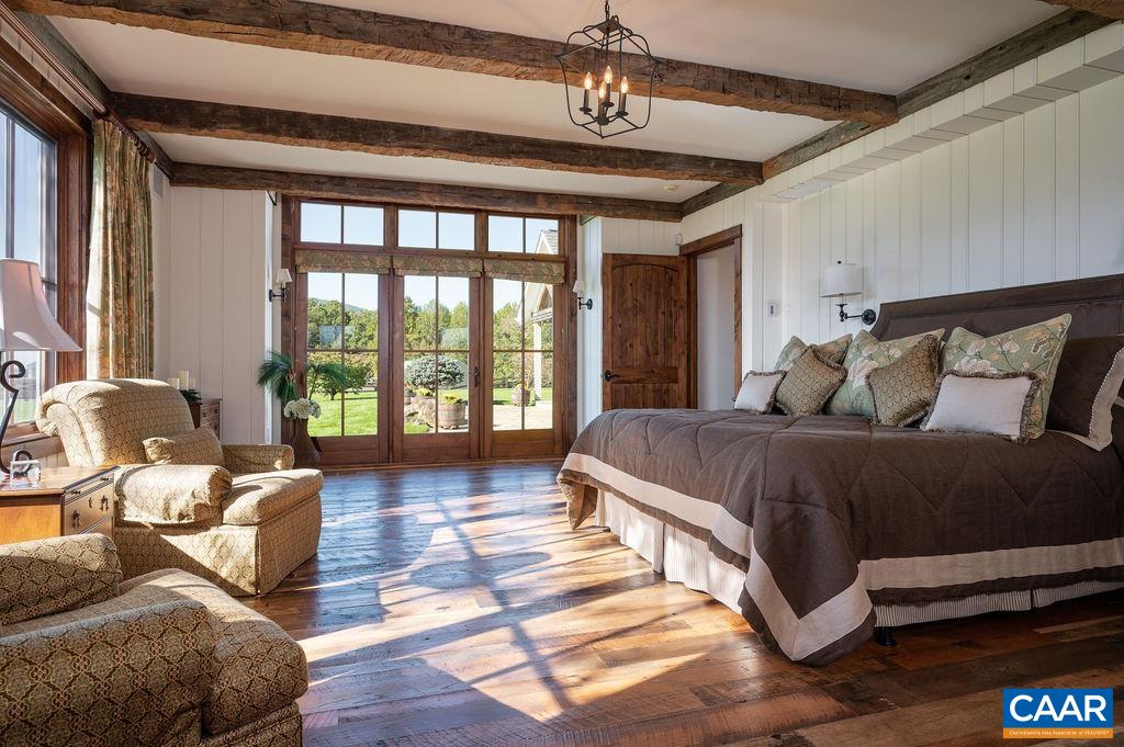 5095 Wesley Chapel Road Free Union, VA 22940 - Photo 26 of 75 a spacious bedroom with a bed couch and a large window
