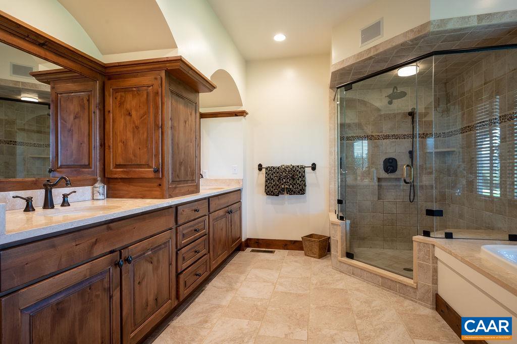 5095 Wesley Chapel Road Free Union, VA 22940 - Photo 28 of 75 a spacious bathroom with a double vanity sink a mirror and a bathtub