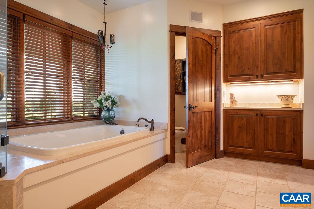 5095 Wesley Chapel Road Free Union, VA 22940 - Photo 29 of 75 a bathroom with a bathtub and a shower